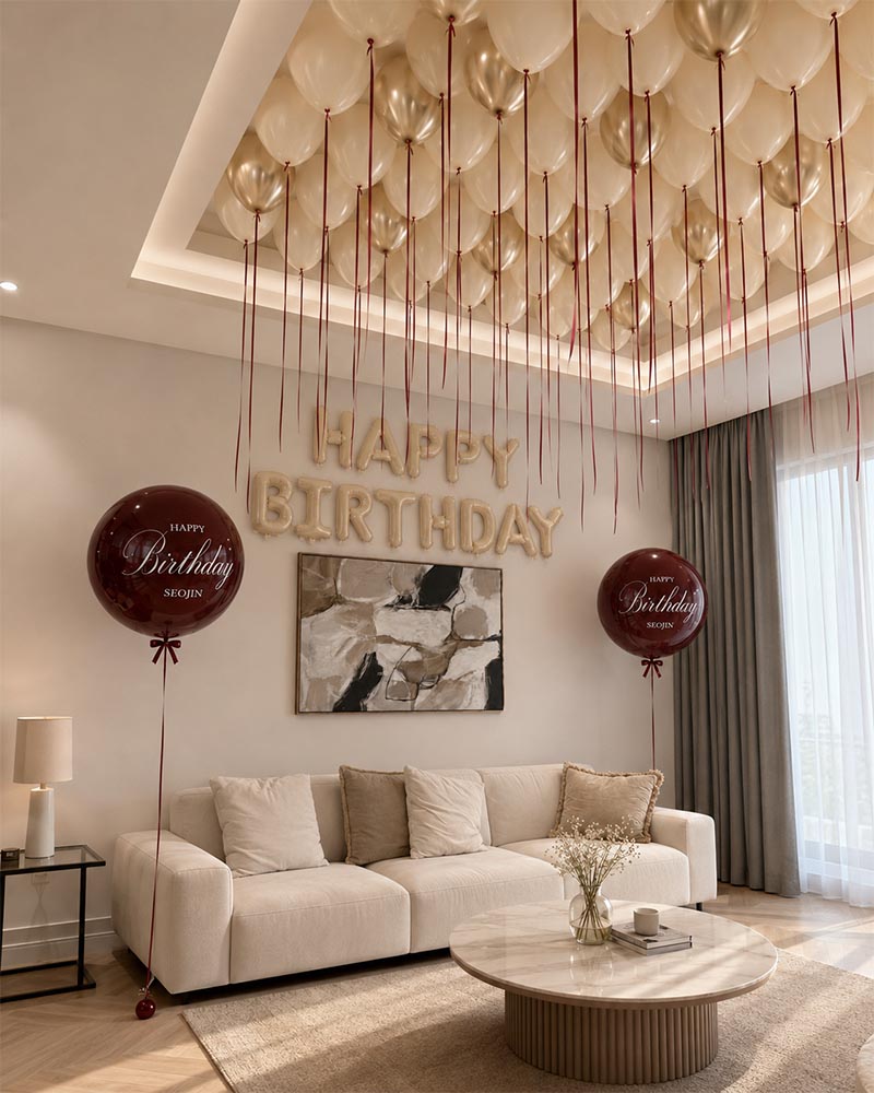 Birthday room decoration Dubai with 40 cream and champagne ceiling balloons, burgundy ribbons, custom Bubble balloons and Happy Birthday letters