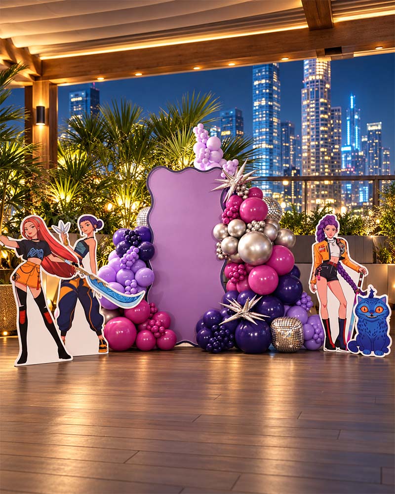 KPop Demon Hunters birthday decoration Dubai with purple backdrop, balloon garland and character cutouts